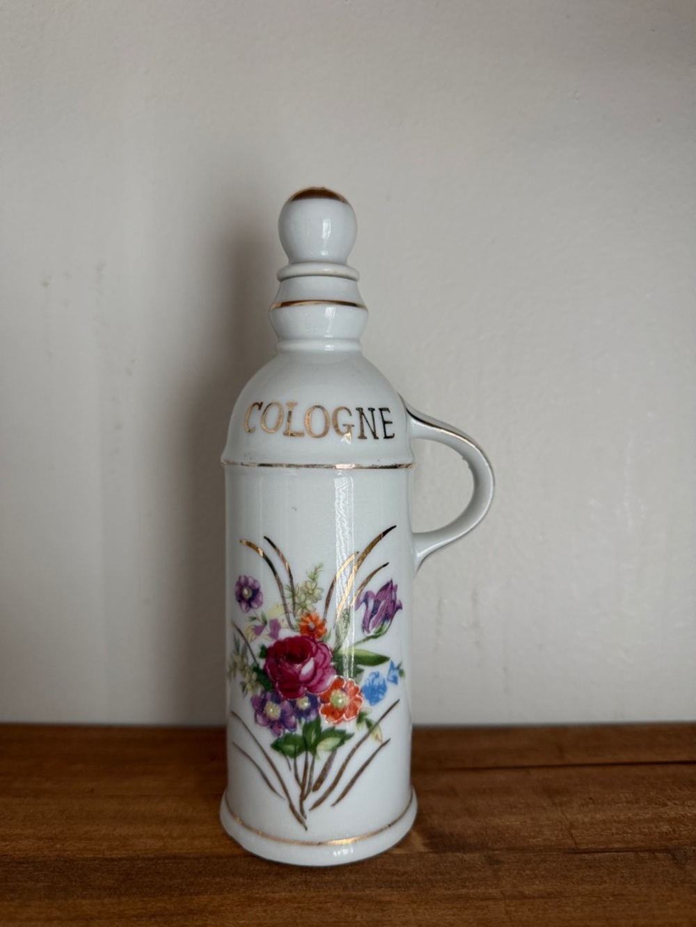 White Floral Cologne Bottle with Gold Accents